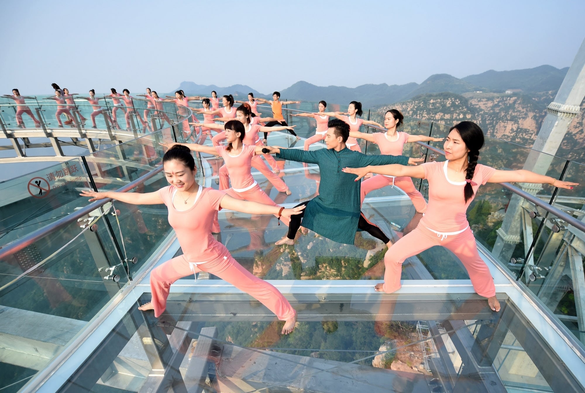 Yoga at a glass sightseeing platform in Shilinxia scenic spot in Pinggu District of Beijing, China.