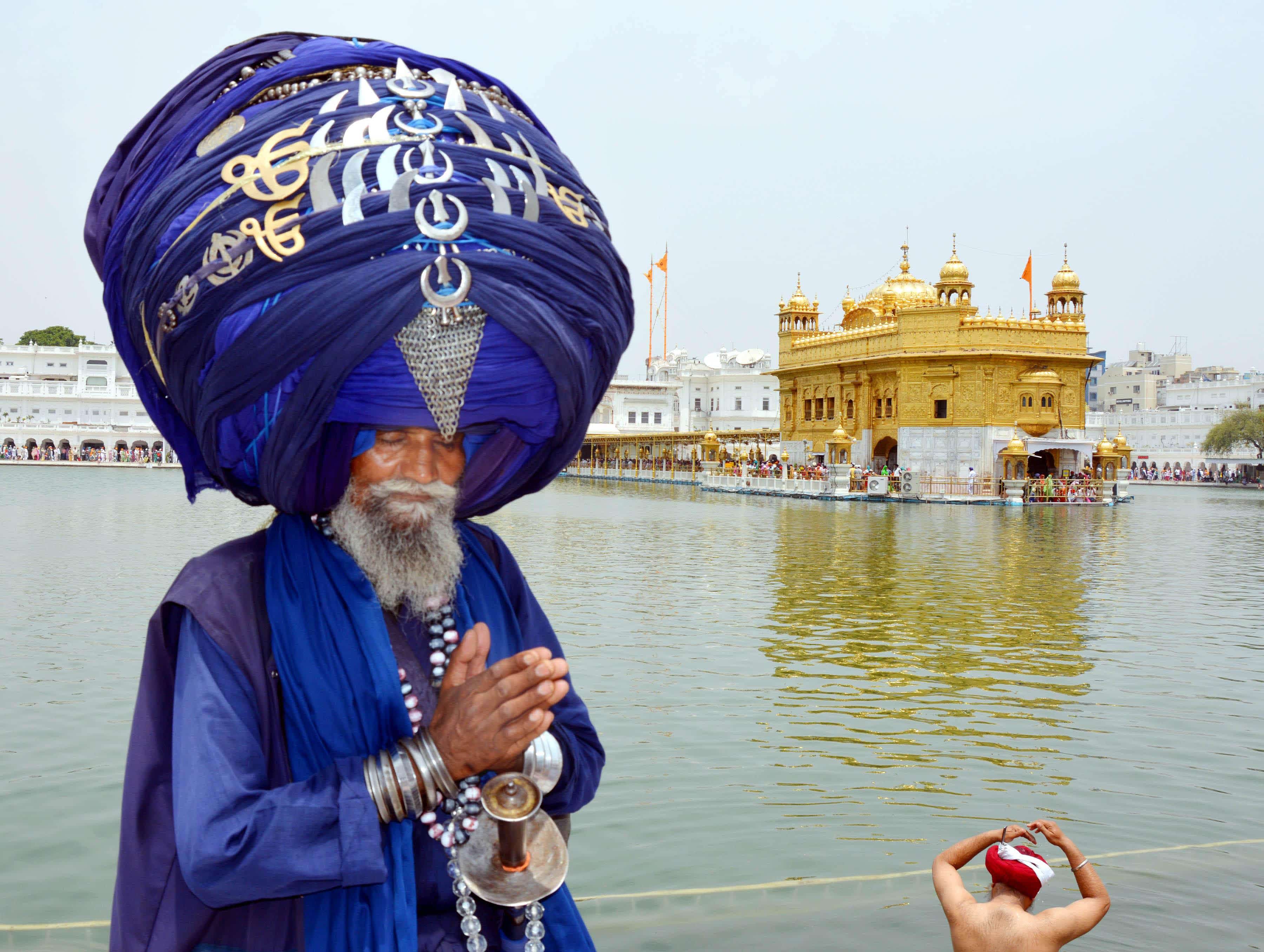 A Sikh Nihang pays obeisance at the Golden Temple in Amritsar.