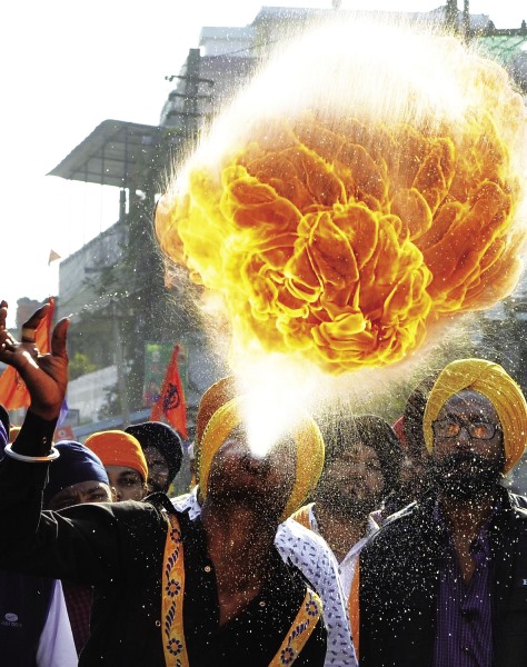 A Sikh devotee performs a fire breathing stunt during the celebration of the 350th birth anniversary of Guru Gobind Singh in Nagaon district in Assam.