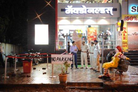 Police and Bomb Detection and Disposal Squad (BDDS) examine the dustbin near Mcdonalds on Jangli Maharaj Road where the minor blast took place on Aug. 1 evening.