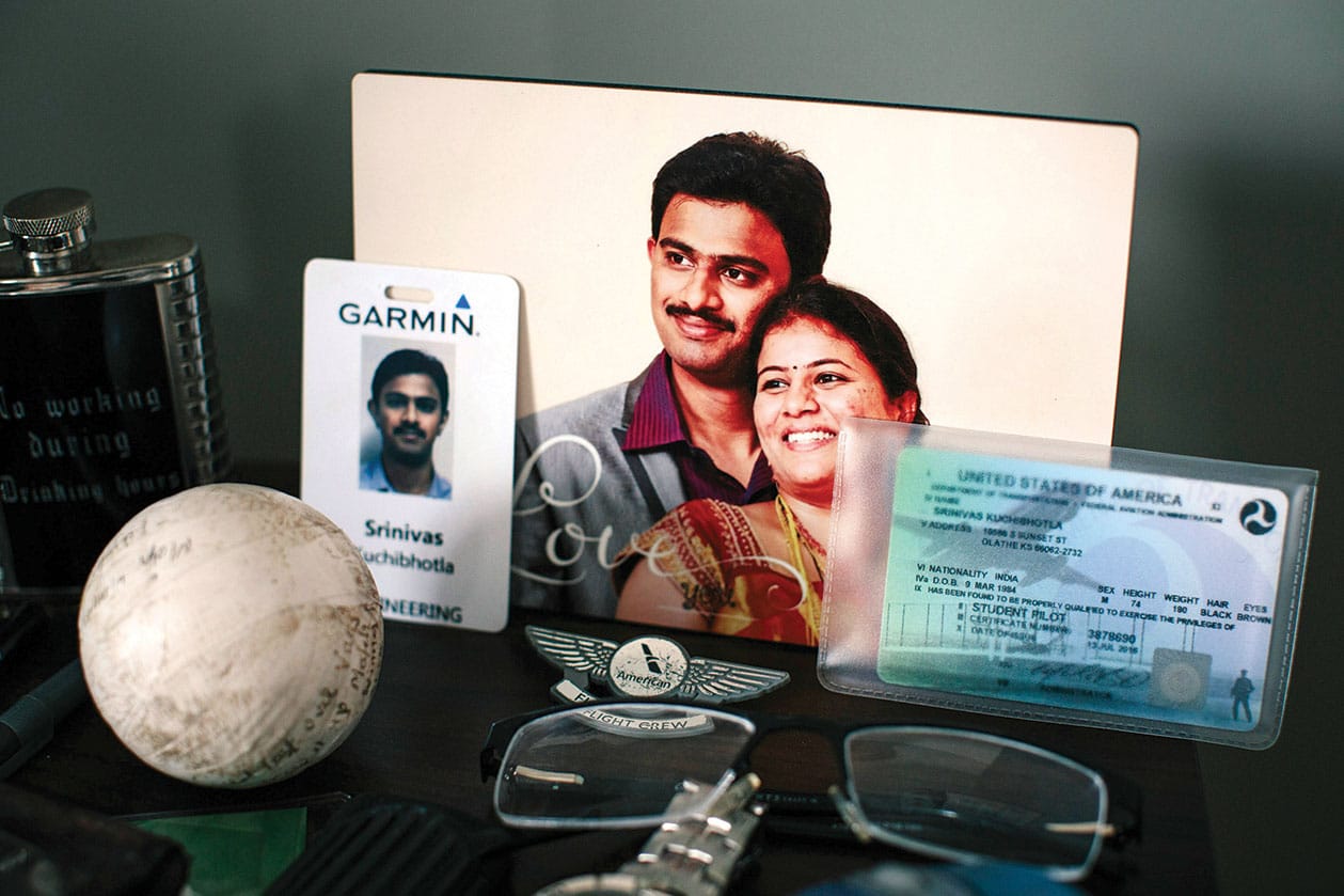 On a night stand, IDs, personal items and a photograph of the couple.