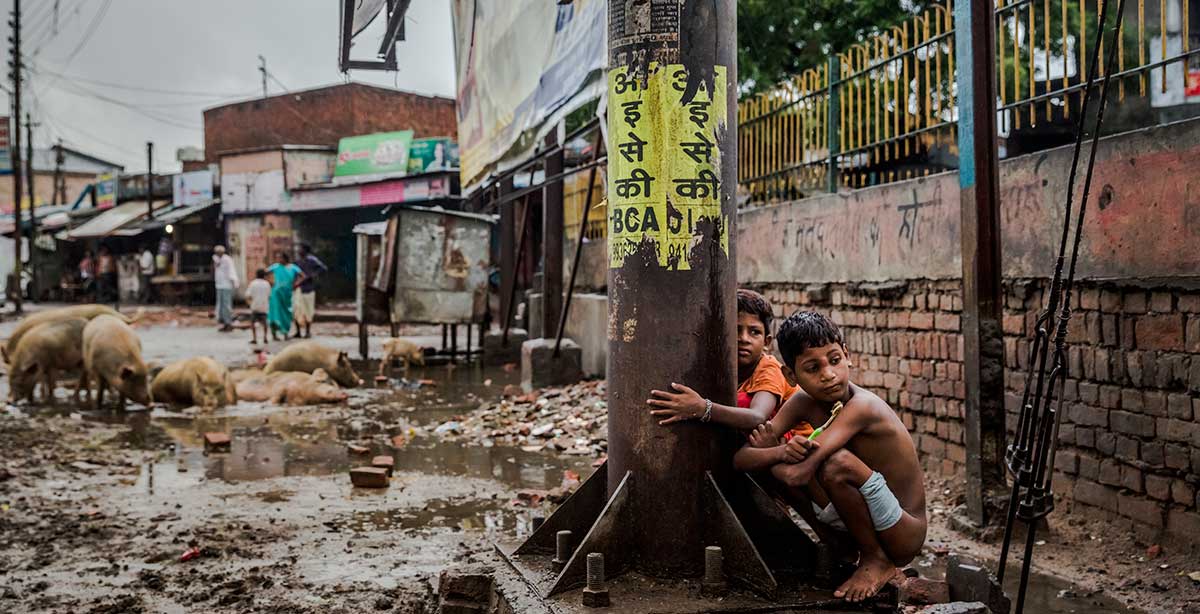 Children defecating outdoors in Varanasi, India, July 6, 2014. Nearly half the population of India — which s embarking on the biggest toilet-building campaign in the nation’s history — still relieve themselves in the open, spreading disease and causing other health problems.