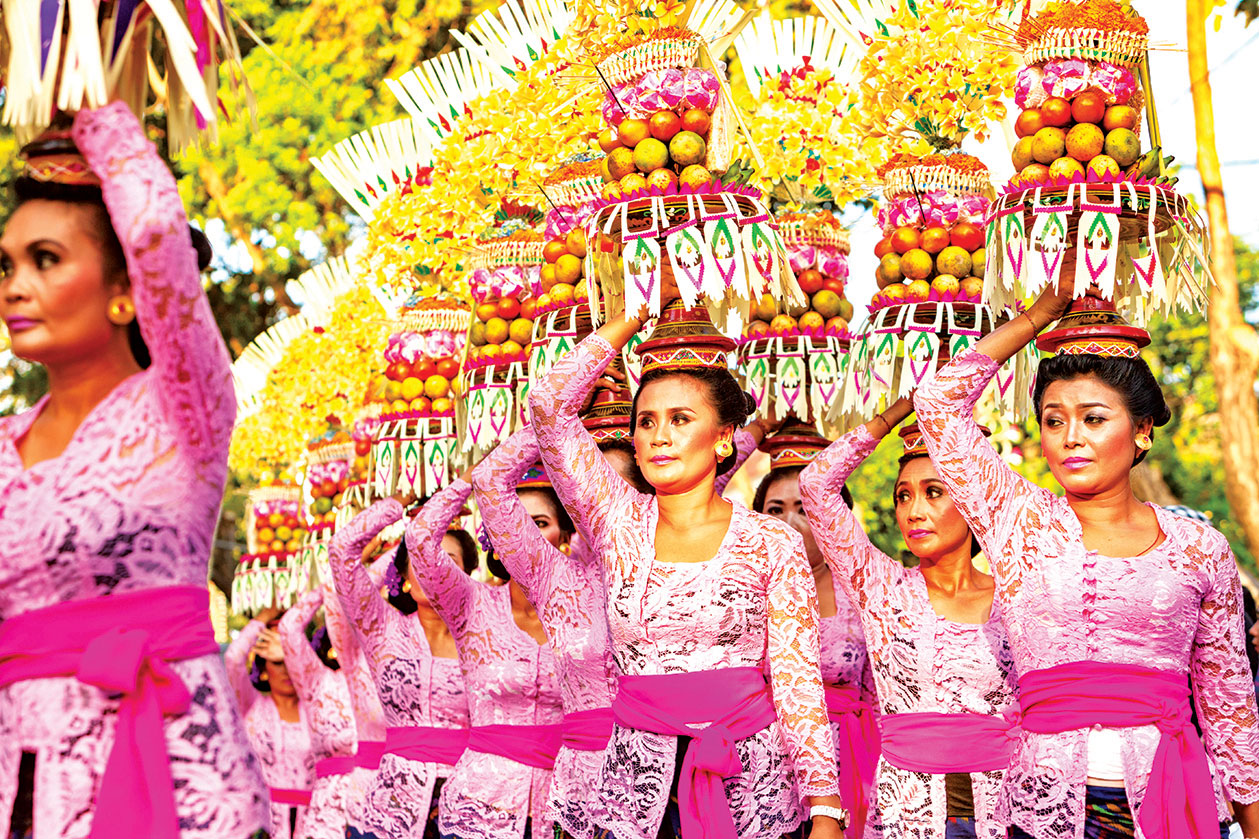 Balinese women carrying offerings for the Hindu ceremony of Mepeed in Denpasar Bali in Indonesia.