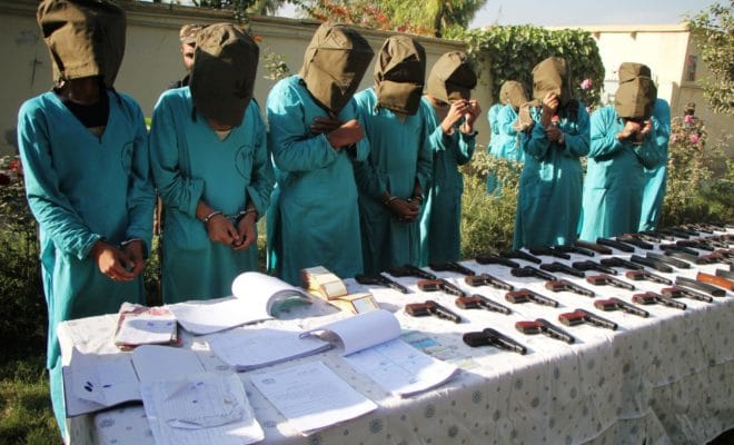 Suspected Islamic state (IS) and Taliban militants stand handcuffed in Nangarhar province, Afghanistan, Dec. 6, 2016.