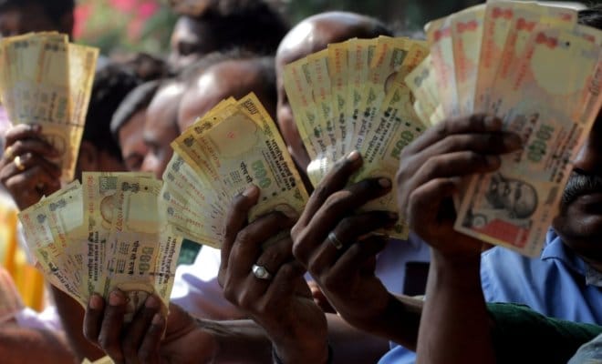 People wait outside a bank branch to exchange old currency notes in Chennai on Nov 10, 2016.