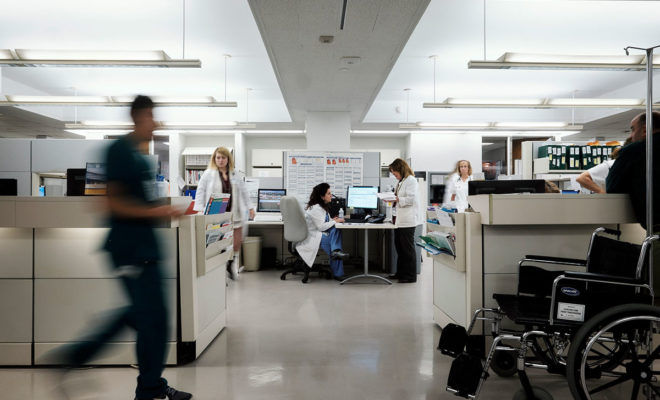 Doctors, nurses and staff around a nurses' station in the orthopedic unit at the Cleveland Clinic in Ohio. The Clinic has faced challenges securing visas for foreign-born specialists, one of many employers affected by President Donald Trump’s tougher approach toward immigration.