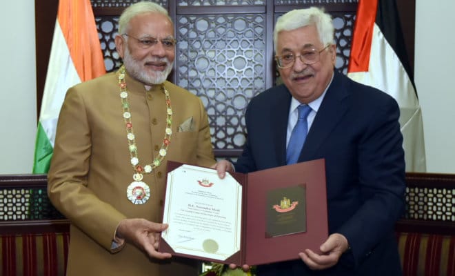 Palestine President Mahmoud Abbas confers the Grand Collar of the State of Palestine on Indian Prime Minister Narendra Modi after the conclusion of their bilateral meeting, at Ramallah on Feb. 10, 2018.