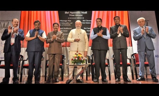 Prime Minister Narendra Modi (center) at the inauguration of the Wadhwani Institute for Artificial Intelligence in Mumbai on Feb.18, 2018, seen with Maharashtra Governor C. Vidyasagar Rao (third from left), Chief Minister Devendra Fadnavis (third from right), Sunil Wadhwani (extreme right), Romesh Wadhwani (extreme left) and other dignitaries.