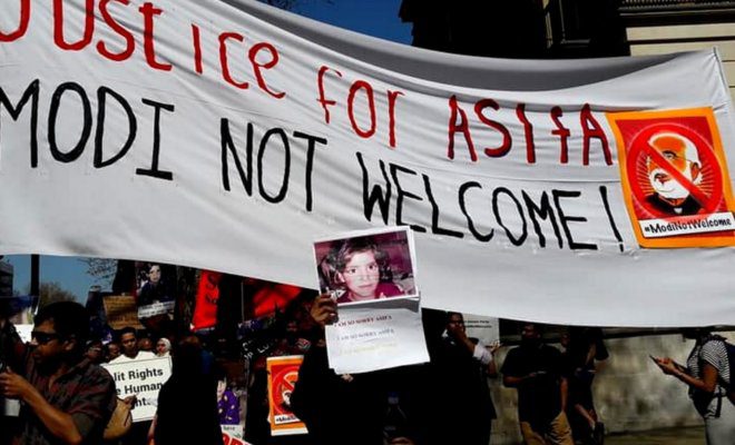 Protesters holding banners condemning the recent rapes under Modi regime in London