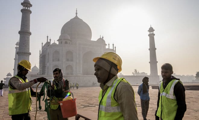 Laborers from the Archeological Survey of India, which is in charge of the Taj Mahal cleaning, in Agra. India’s Supreme Court on May 9 reprimanded the Archaeological Survey of India for failing to protect the Taj Mahal from dirty feet and insects.