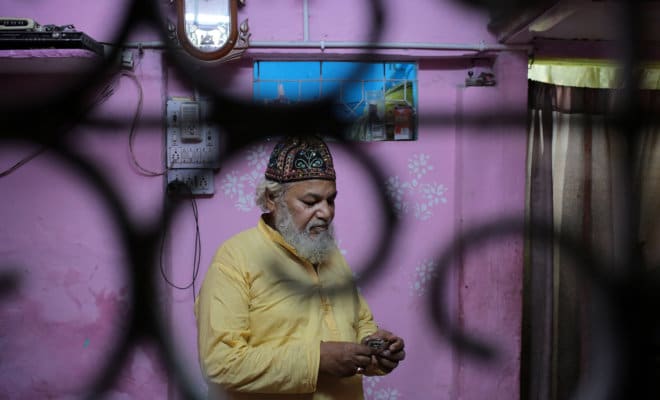 Mohammed Shafiq, a town crier, prepares to make his rounds to wake neighbors for a pre-dawn meal during Ramadan in the Old Delhi quarter of New Delhi.