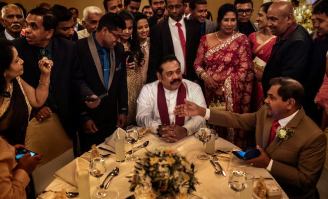 Former President Mahinda Rajapaksa of Sri Lanka, center, at a wedding in Colombo, Sri Lanka, June 6, 2018.