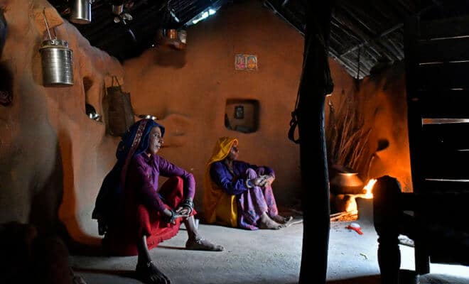 Women cook food by fire in a home in Kraska, India, on April 16, 2018.