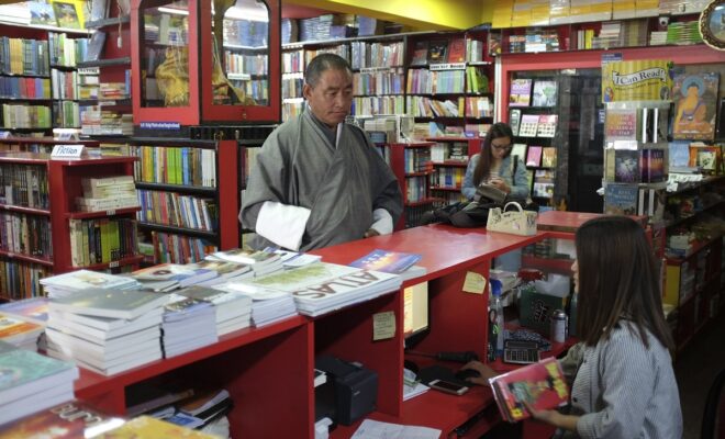 A customer buys a book at DSB Books in Thimphu, which claims to be the oldest bookstore in Bhutan.