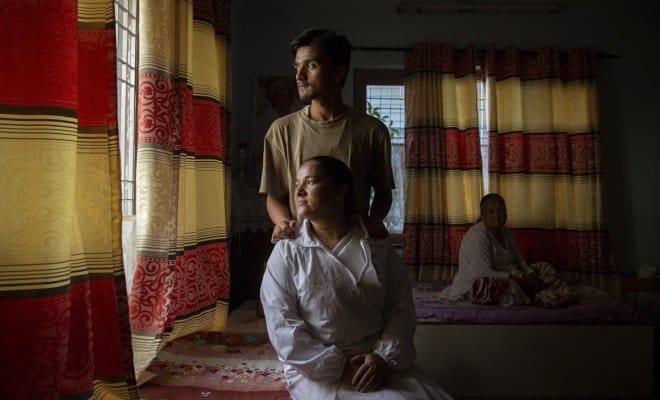 Ganga Mahat Subedi, whose husband was among the 15 contractors to the Canadian Embassy killed in a 2016 suicide bombing in Afghanistan, with her son in Kathmandu, Nepal, July 13, 2018.