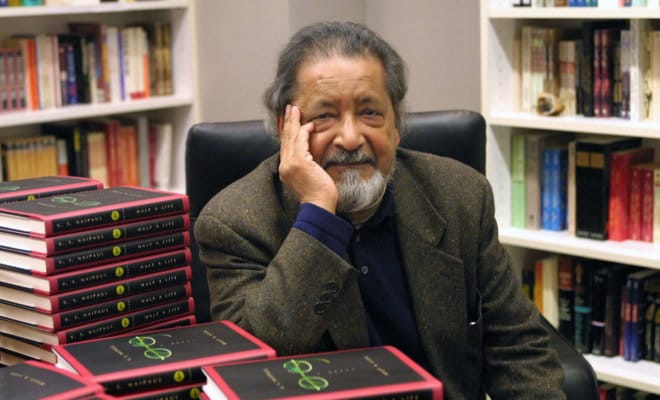The author V.S. Naipaul, with copies of his novel