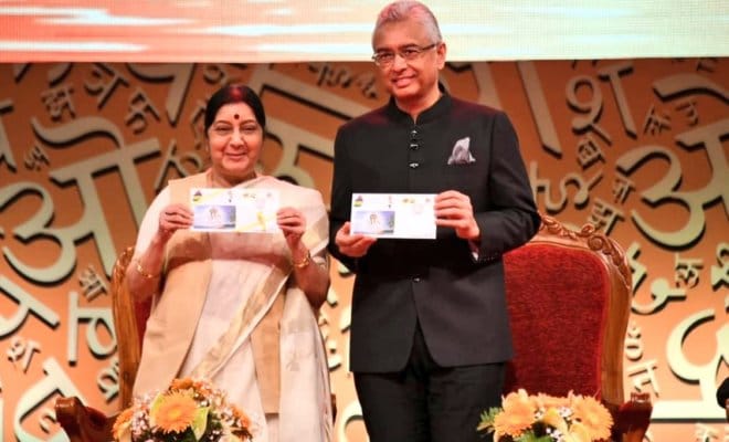 Mauritius Prime Minister Pravind Jugnauth (right) and Indian External Affairs Minister Sushma Swaraj unveiling stamps issued by Mauritius Postal Department at the 11th World Hindi Conference at Port Louis on Aug. 18, 2018.
