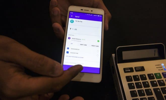 The PhonePe mobile app on a smartphone, left, and a point-of-sale device are demonstrated during a product unveiling in Bengaluru, India, on on Oct. 31, 2017.