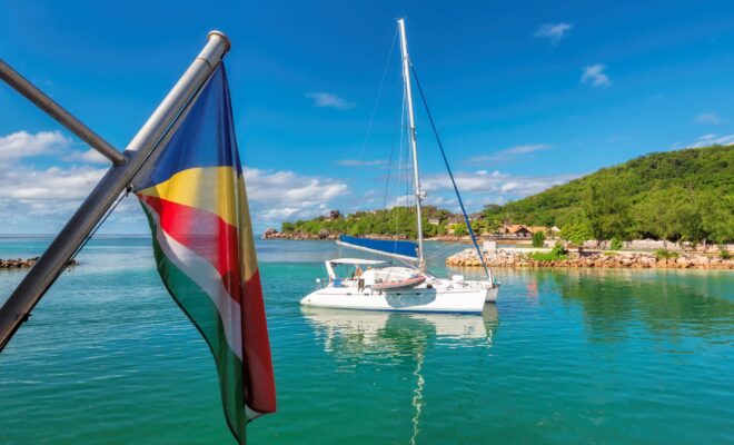 A yacht and Seychelles flag at La Digue island.