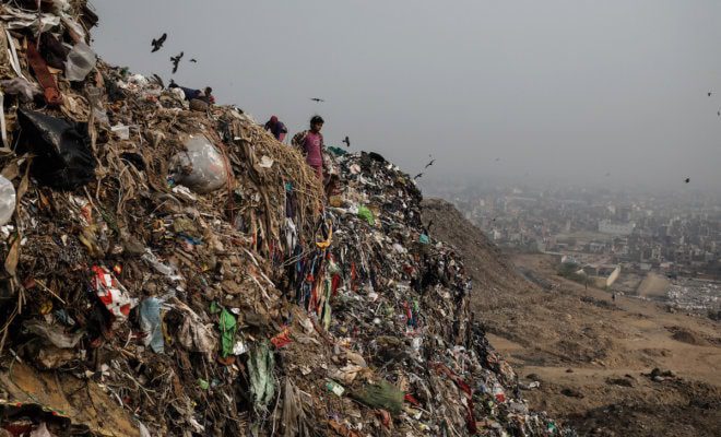 People separate waste at the Bhalswa landfill in New Delhi. As the country’s politics have veered to the right and become increasingly divisive, the justices of India’s Supreme Court have often acted as a progressive counterweight.