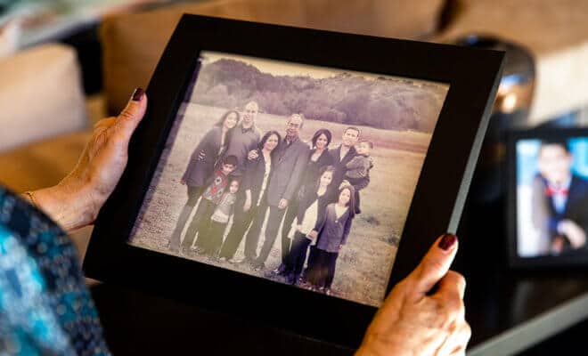 Amita Patel holds a photo of her family, at her home in Las Vegas.