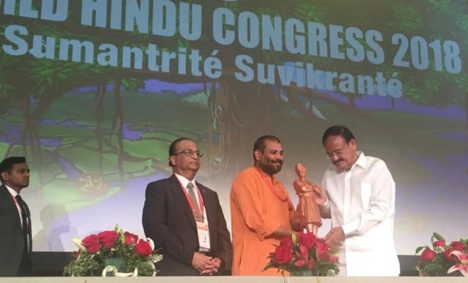 Swami Vigyanananda & Dr. Bharat Baria present a statue of Swami Vivekananda to Vice President M Venkaiah Naidu at World Hindu Congress in Chicago.
