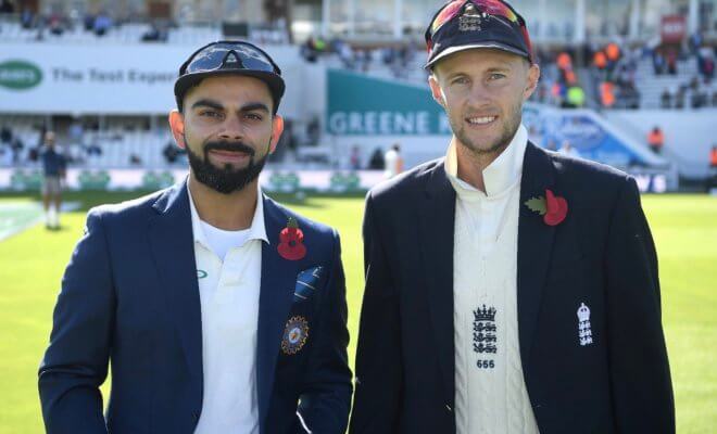 Virat Kohli and Joe Root wear the special khadi poppy during the fifth Test match at Oval in London on Sept. 7.