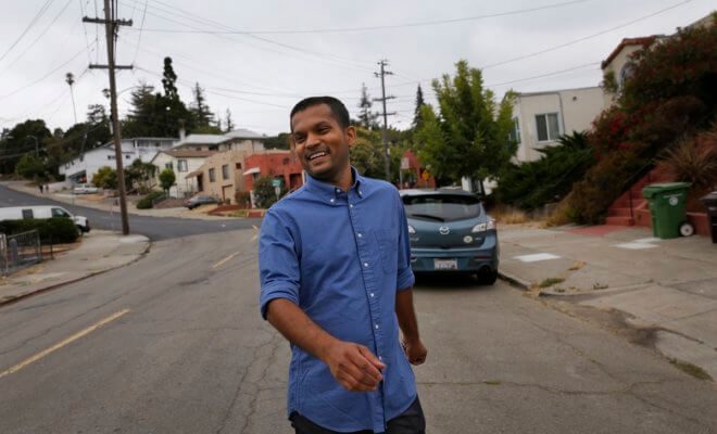 Nik Sharma walks through his neighborhood in Oakland, Calif., Aug. 14, 2018.