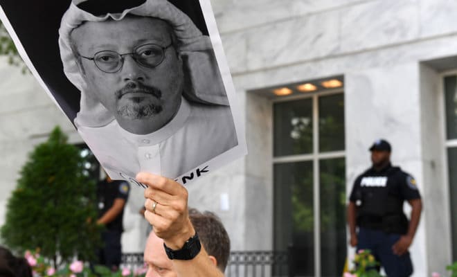 Michael Beer holds a poster during a rally about the disappearance of Washington Post journalist Jamal Khashoggi outside the Embassy of Saudi Arabia on Oct. 10, 2018, in Washington.