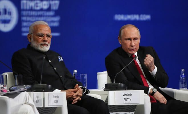 Russian President Vladimir Putin (right) gestures as he speaks while Indian Prime Minister Narendra Modi looks on during the St. Petersburg International Economic Forum in Saint Petersburg, Russia.