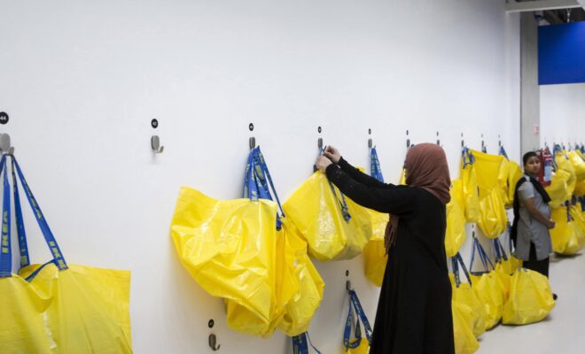 A customer picks up a branded shopping bag inside the Ikea store in Hitech City on the outskirts of Hyderabad, India in August.