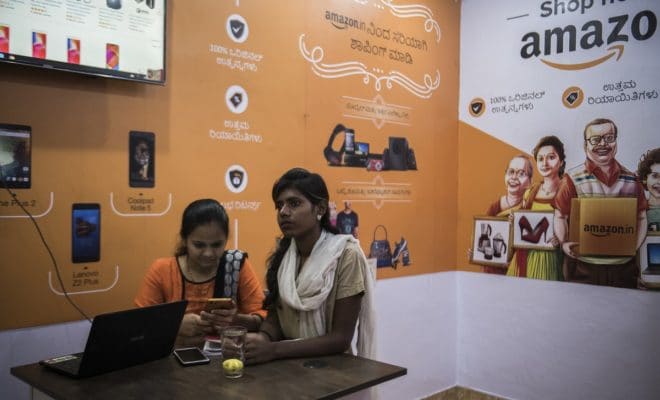 Employees at an Amazon order and collection point in Tumakuru, India, Dec. 4, 2018. The Indian government dealt a surprise blow on Dec. 26 to the e-commerce ambitions of Amazon and Walmart, effectively barring the American companies from selling products supplied by affiliated companies on their Indian shopping sites and from offering their customers special discounts or exclusive products.
