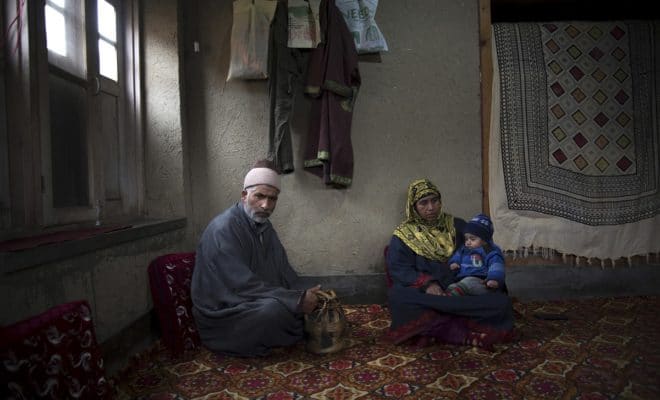 Mohammad Ashraf Bhat and his wife, Naza Bano, parents of Numan Ashraf Bhat, who was fatally shot at age 16 while trying to prevent Indian forces from killing a militant, in Balsoo, India, Dec. 12, 2018. Indian forces hunting for separatist fighters now regularly face angry crowds seeking to defend them. Scores of civilians have been killed.